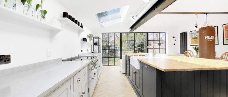 Open kitchen area with large modern counters and two pitched skylights.
