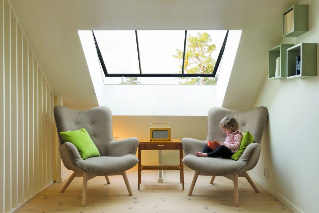 Toddler reading under large conservation pitched rooflight