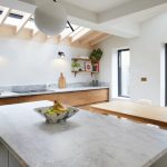 Pitched rooflights with exposed rafters in kitchen dining area