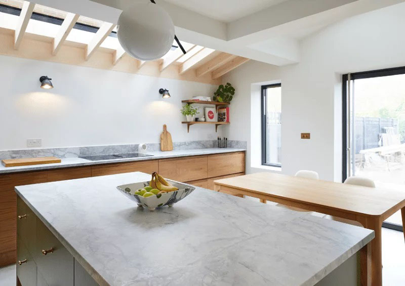 Pitched rooflights with exposed rafters in kitchen dining area