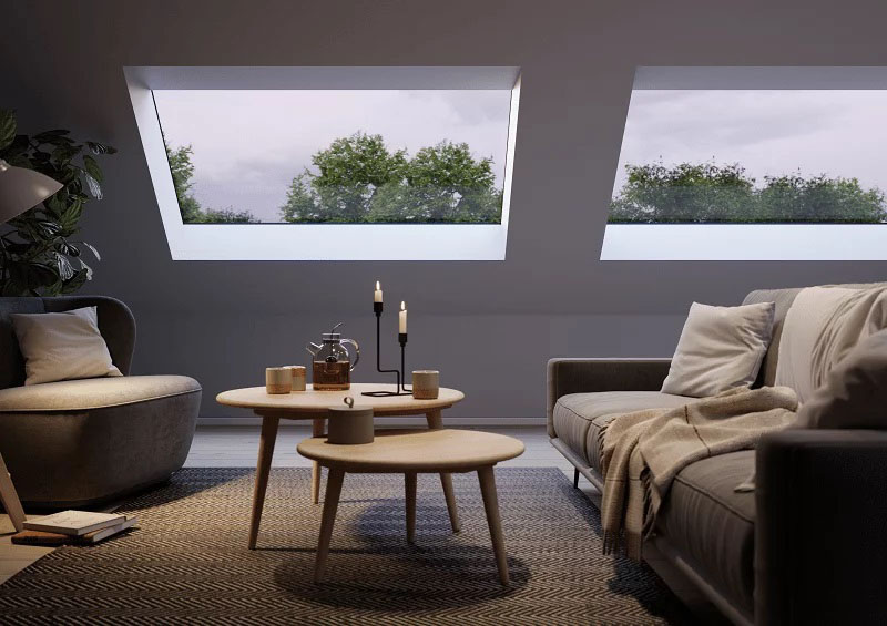 Cosy living area, at evening time, with large pitched rooflight and candles